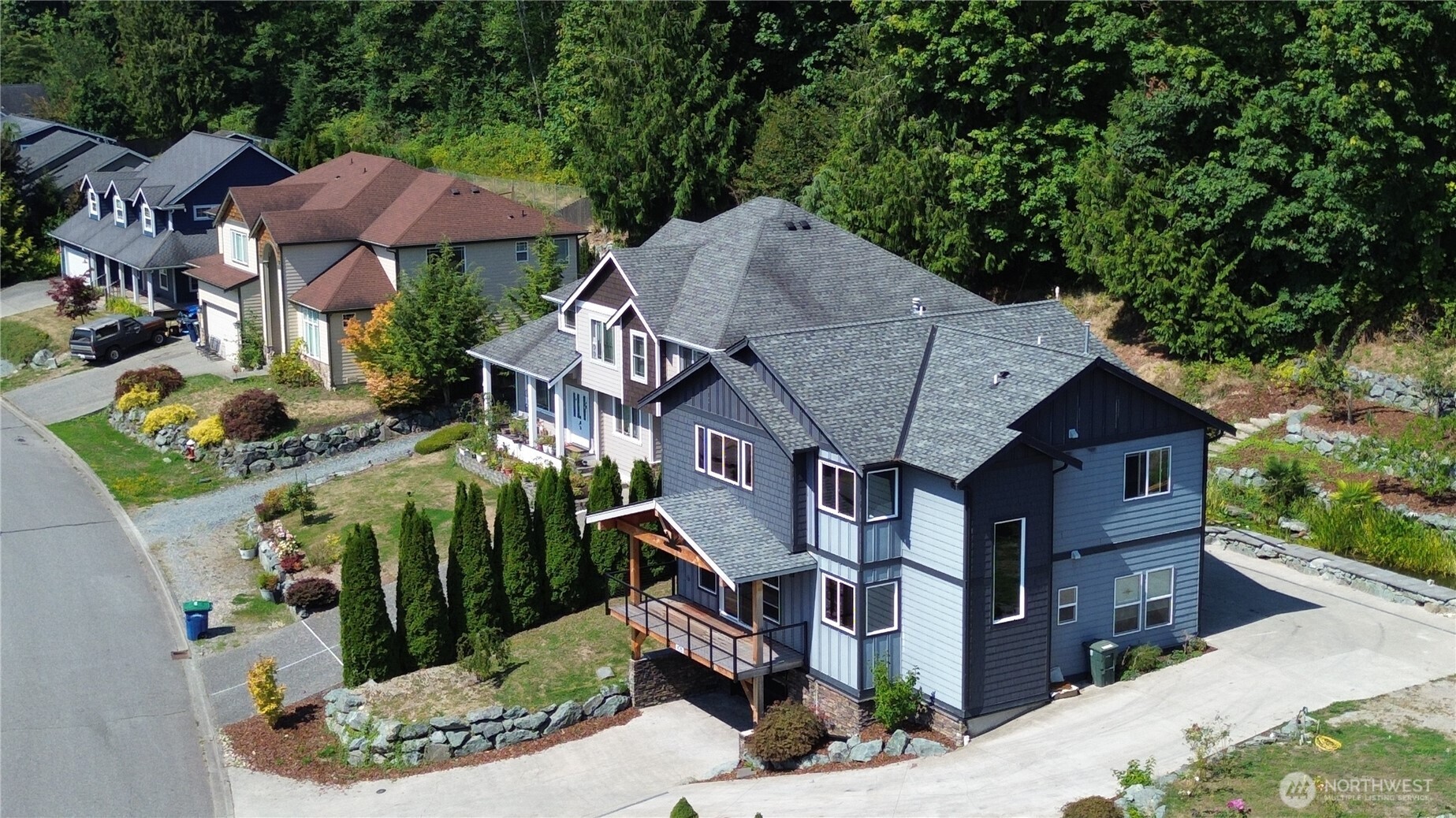 426 Longtime Lane Sedro-Woolley, WA 98284 - Photo 1 of 28 a aerial view of a house with table and chairs under an umbrella