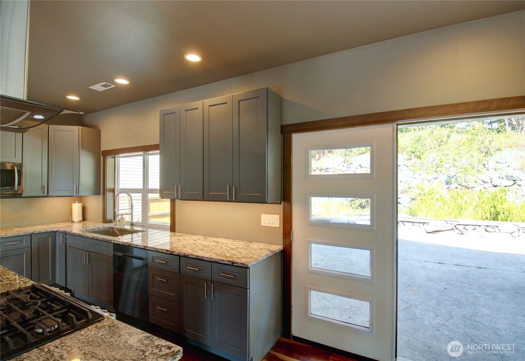426 Longtime Lane Sedro-Woolley, WA 98284 - Photo 5 of 28 a kitchen with granite countertop a sink and a stove