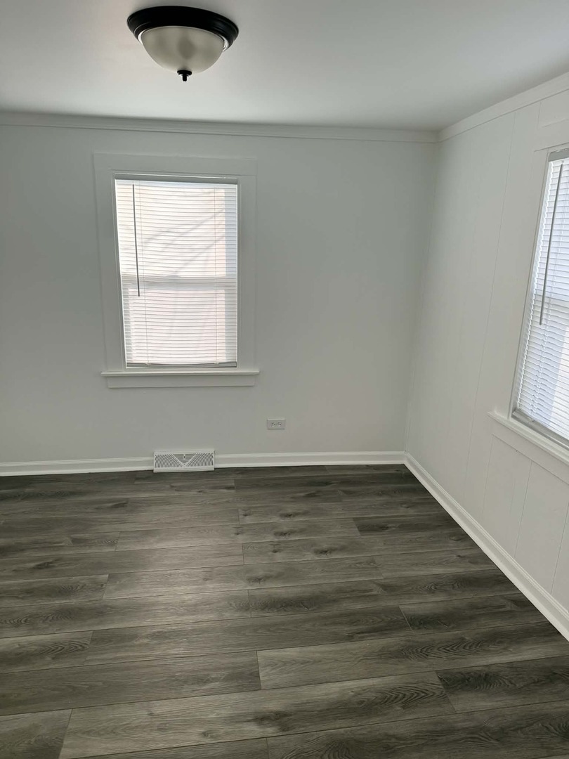 3634 Sangamon Street Steger, IL 60475 - Photo 12 of 17 an empty room with wooden floor and windows
