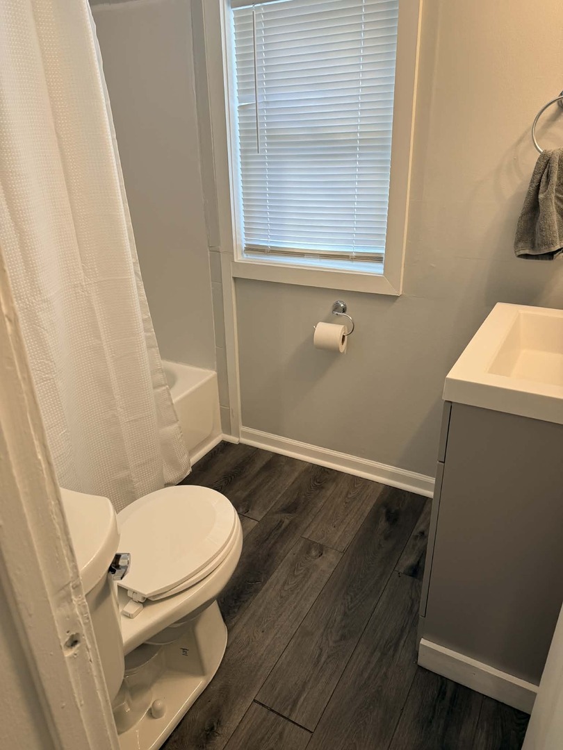 3634 Sangamon Street Steger, IL 60475 - Photo 14 of 17 a white toilet sitting next to a bathroom sink and a tub