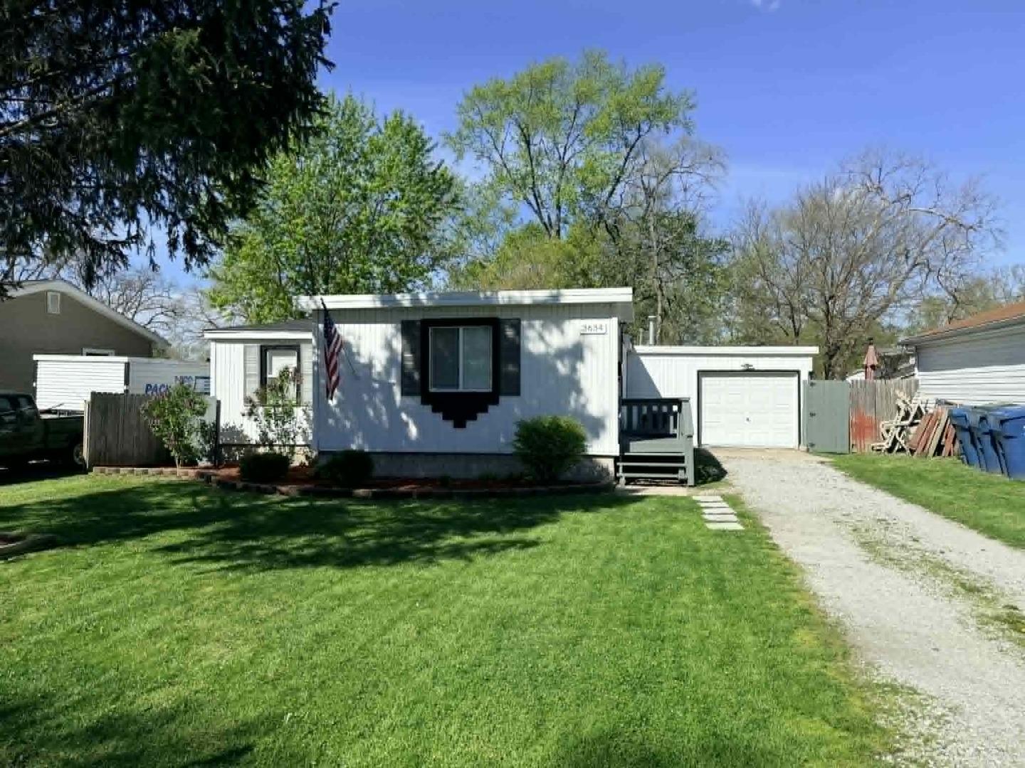 3634 Sangamon Street Steger, IL 60475 - Photo 2 of 17 a front view of a house with a garden