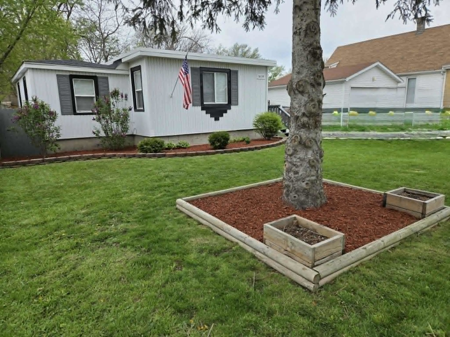 3634 Sangamon Street Steger, IL 60475 - Photo 5 of 17 a view of a house with a yard and a tree