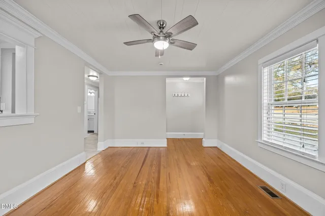 wooden floor in an empty room with a bathroom