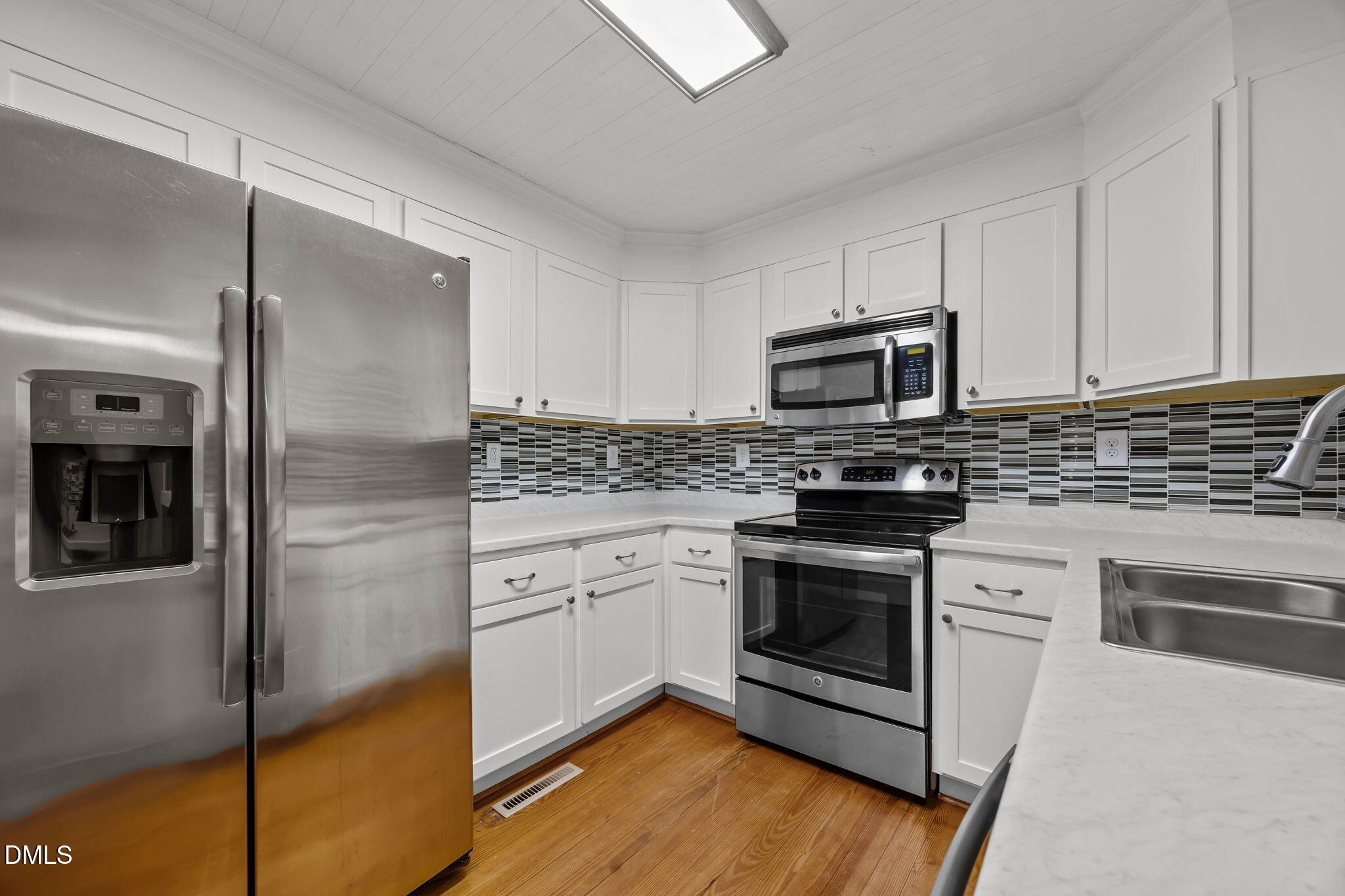 5869 Deans Street Bailey, NC 27807 - Photo 25 of 62 a kitchen with granite countertop stainless steel appliances and wooden cabinets