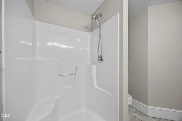 a view of a balcony with floor to ceiling window and wooden floor