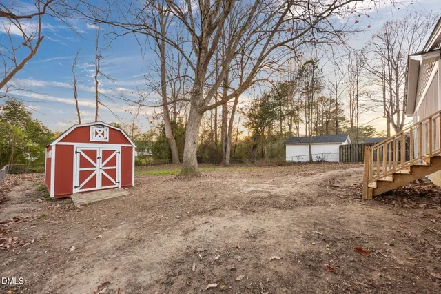 a view of a porch with furniture and a yard
