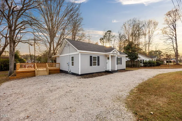 a view of a house with a yard covered with snow in front of house