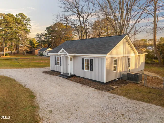 an aerial view of a house with a yard table and chairs