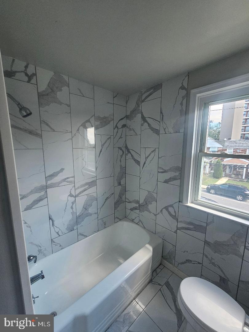 506 Allendale Street Baltimore, MD 21229 - Photo 13 of 27 a bathroom with a tub a toilet and a shower