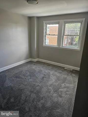 a view of room with window and hardwood floor