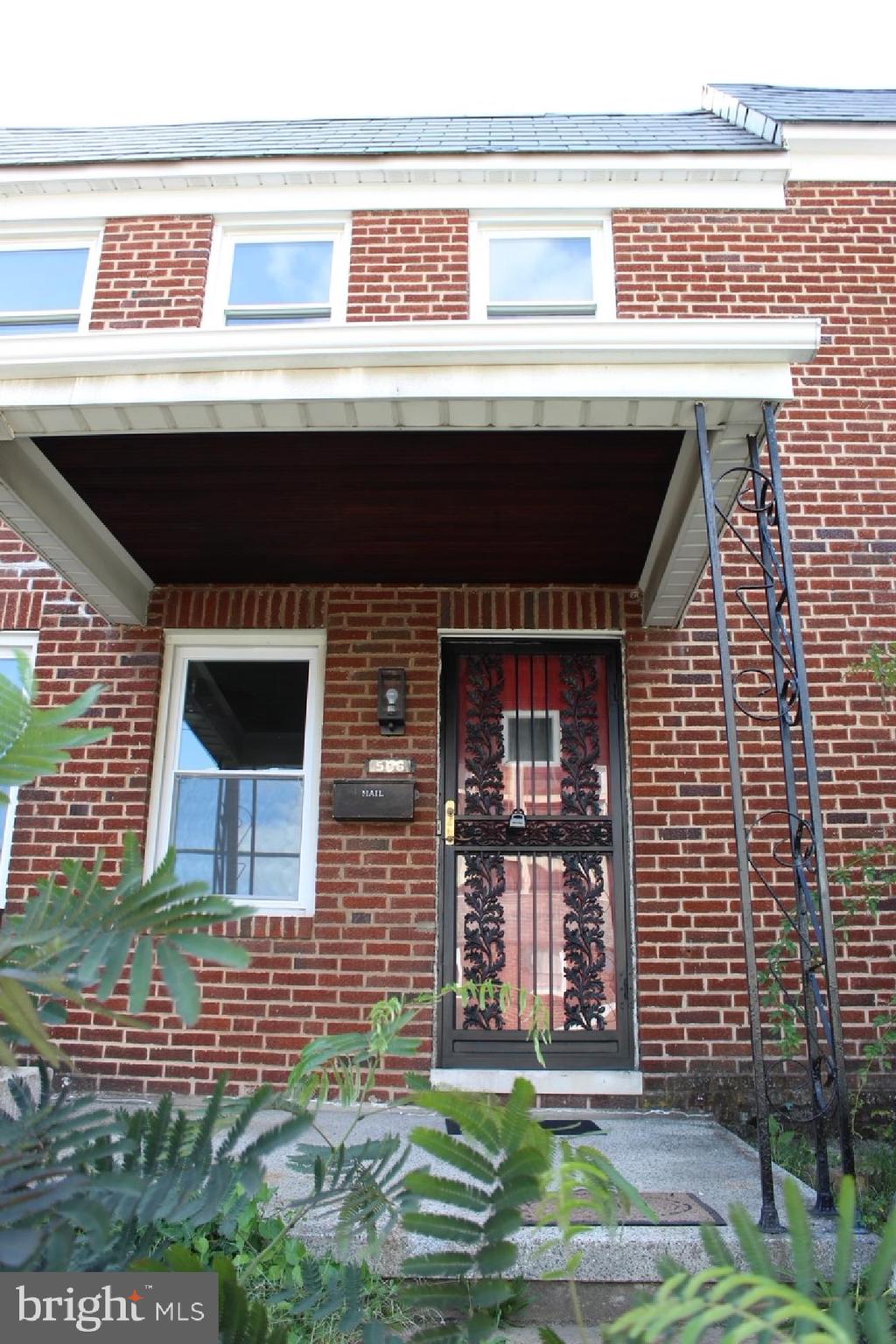 506 Allendale Street Baltimore, MD 21229 - Photo 2 of 27 a front view of a house with garden