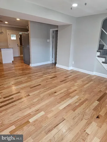 a view of a room with wooden floor