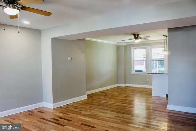a view of empty room with wooden floor
