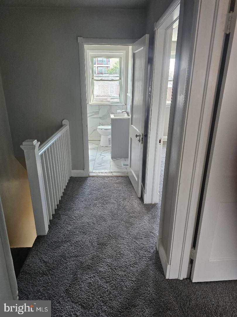 506 Allendale Street Baltimore, MD 21229 - Photo 9 of 27 a view of a hallway with windows