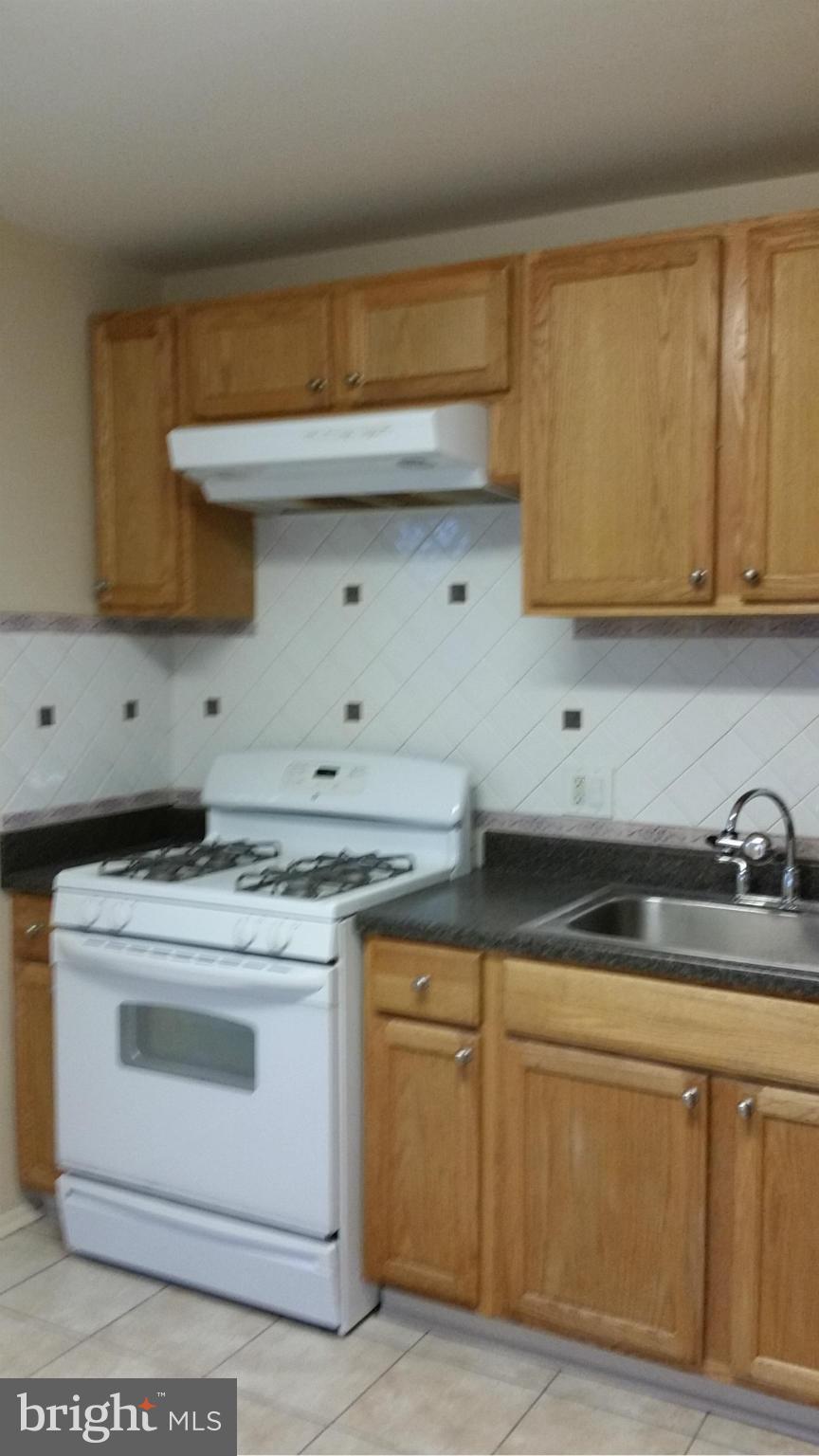 337 Bryanstone Road Reisterstown, MD 21136 - Photo 12 of 25 a kitchen with granite countertop a sink a stove and cabinets