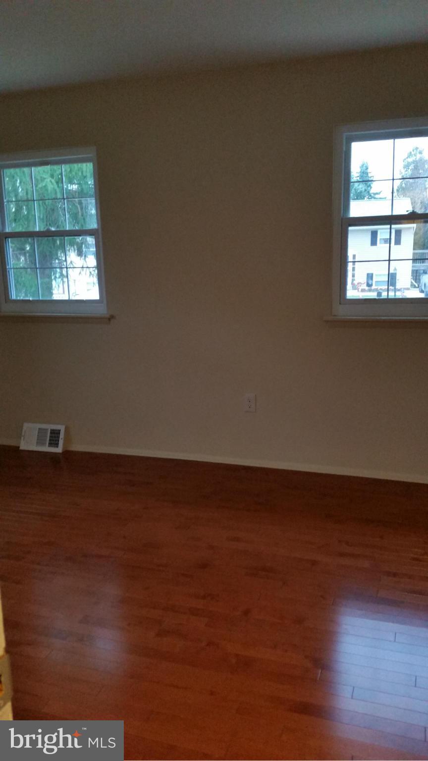 337 Bryanstone Road Reisterstown, MD 21136 - Photo 15 of 25 an empty room with wooden floor and windows