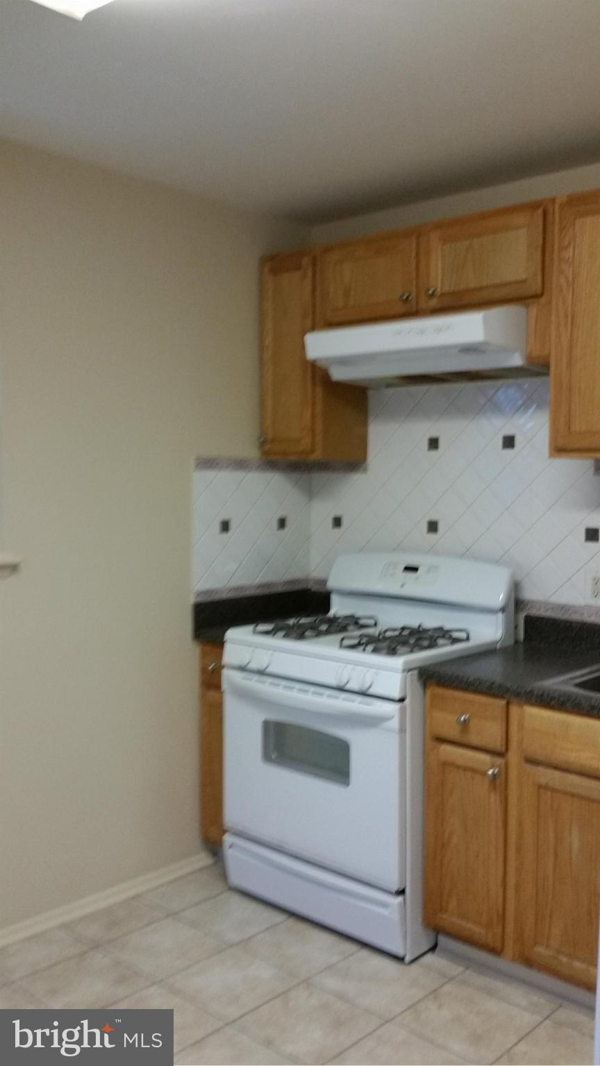 337 Bryanstone Road Reisterstown, MD 21136 - Photo 17 of 25 a kitchen with a stove and cabinets