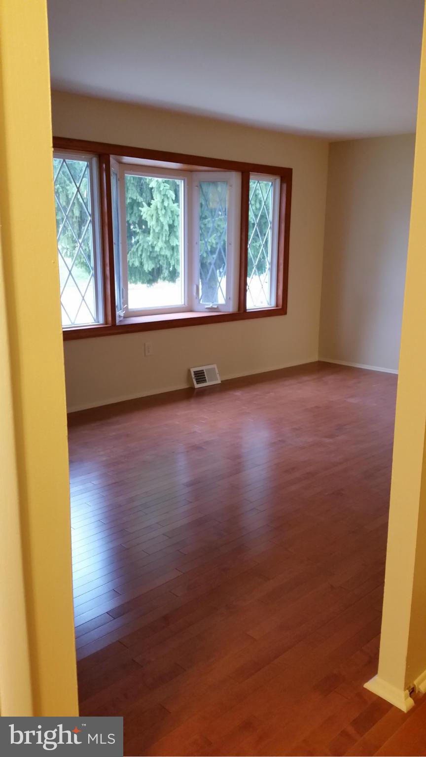337 Bryanstone Road Reisterstown, MD 21136 - Photo 20 of 25 a view of an empty room with wooden floor and a window