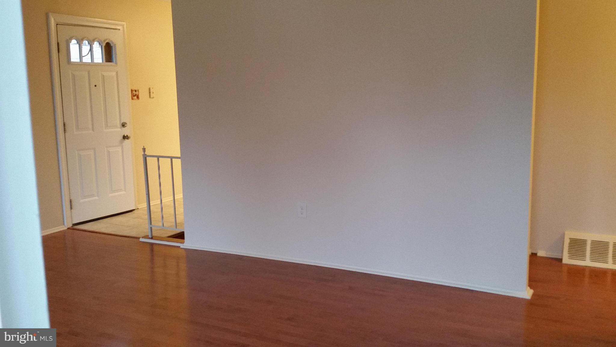 337 Bryanstone Road Reisterstown, MD 21136 - Photo 21 of 25 an empty room with wooden floor and windows