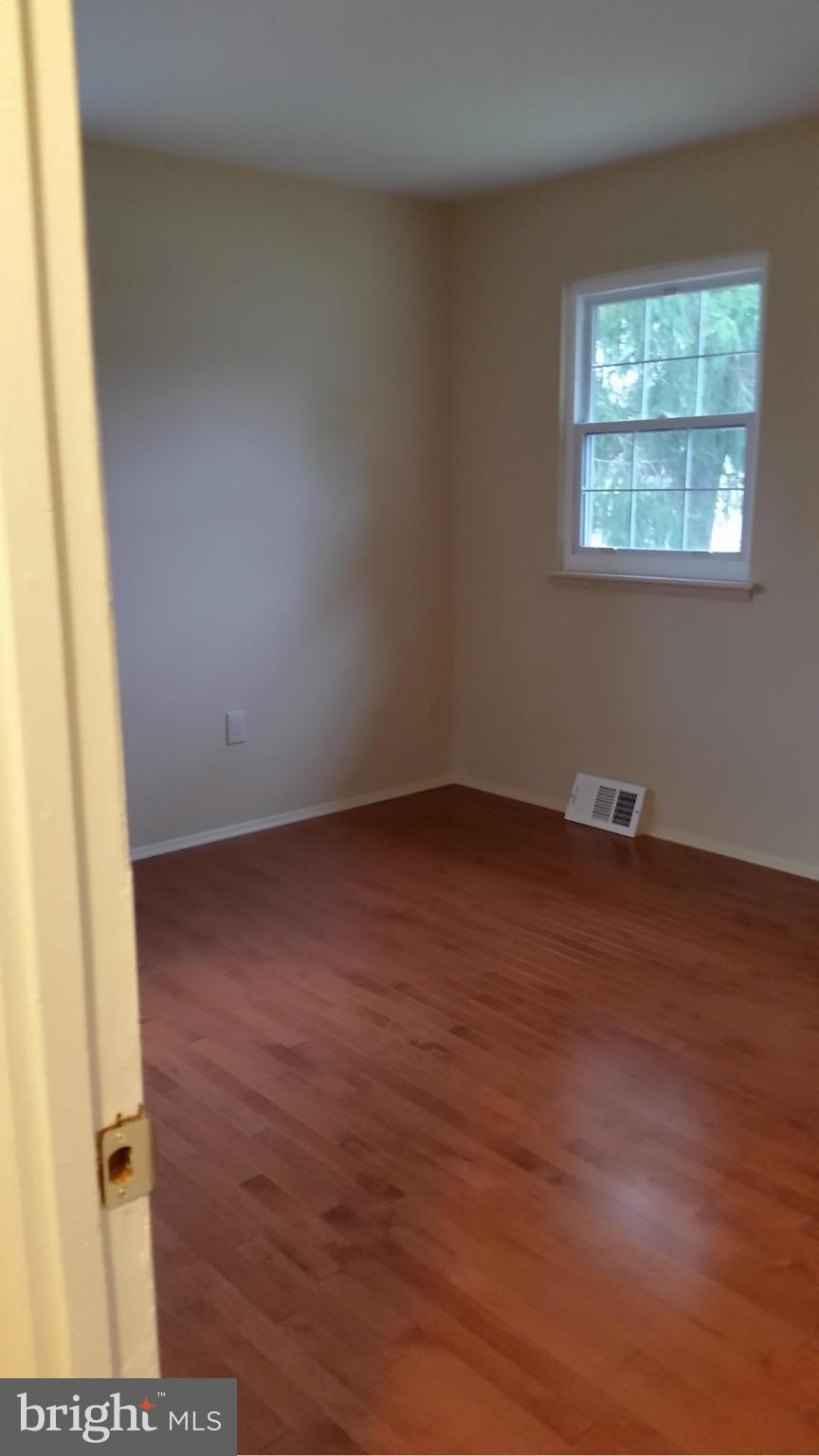 337 Bryanstone Road Reisterstown, MD 21136 - Photo 25 of 25 a view of an empty room with wooden floor and a window