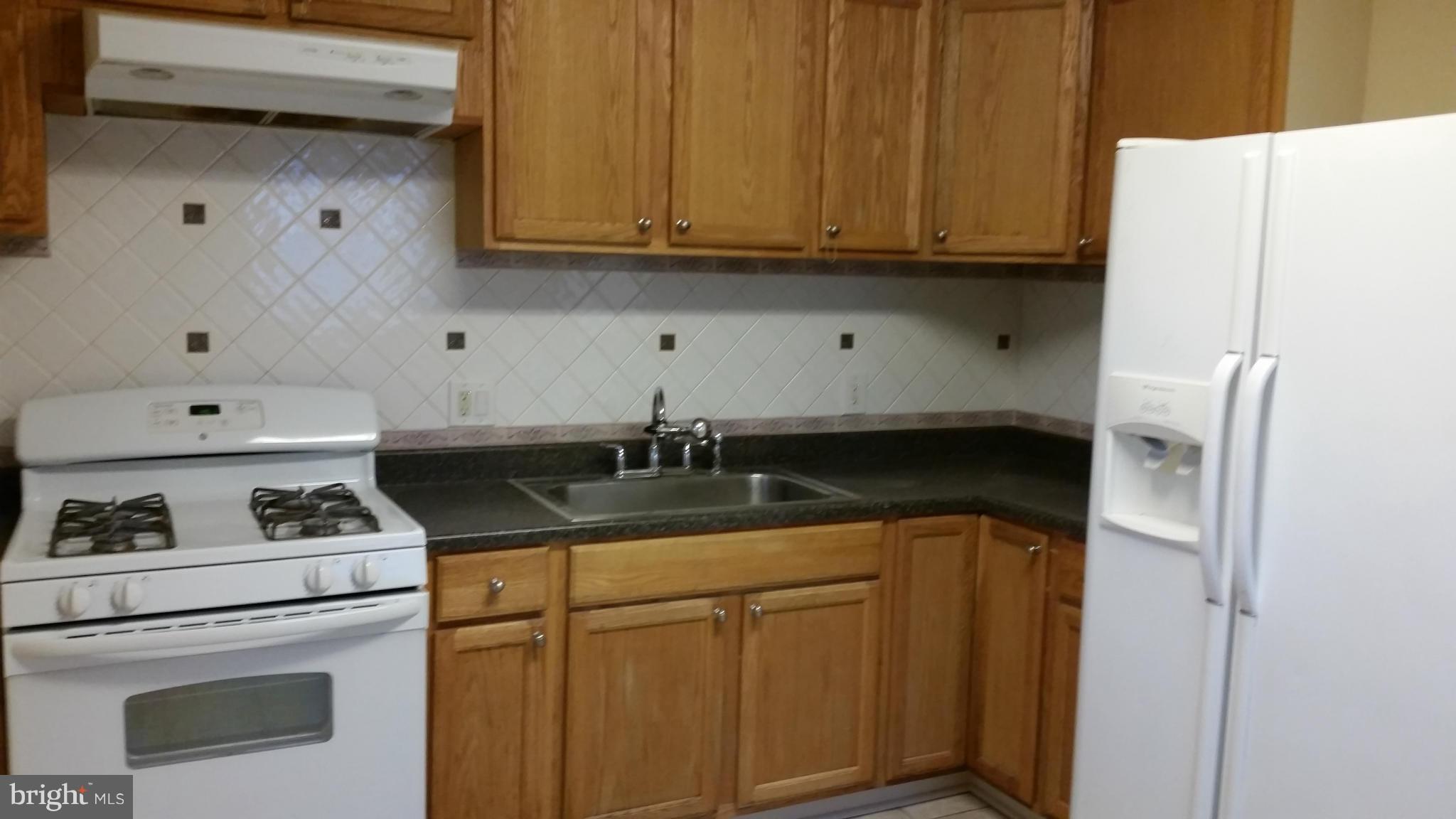337 Bryanstone Road Reisterstown, MD 21136 - Photo 8 of 25 a kitchen with a stove and a refrigerator
