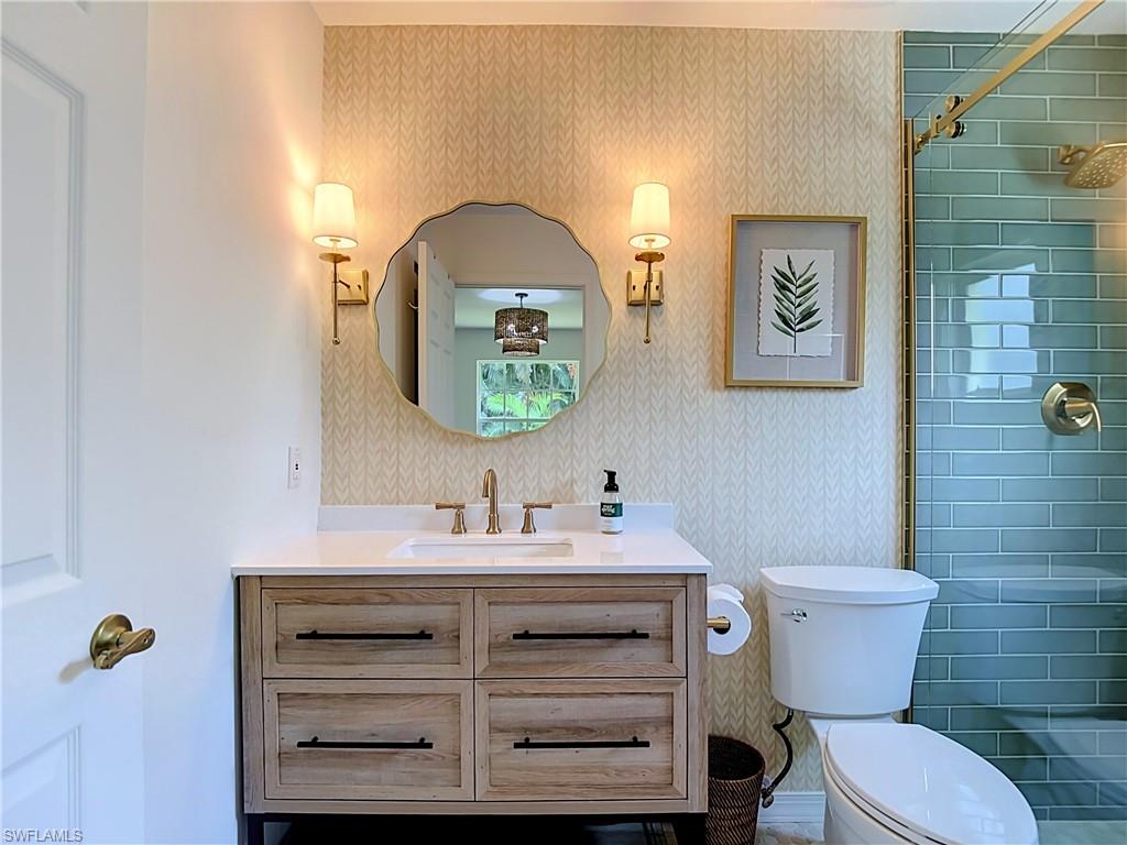 812 102nd Avenue North Naples, FL 34108 - Photo 29 of 33 Single vanity with a white countertop and gold-finish faucet