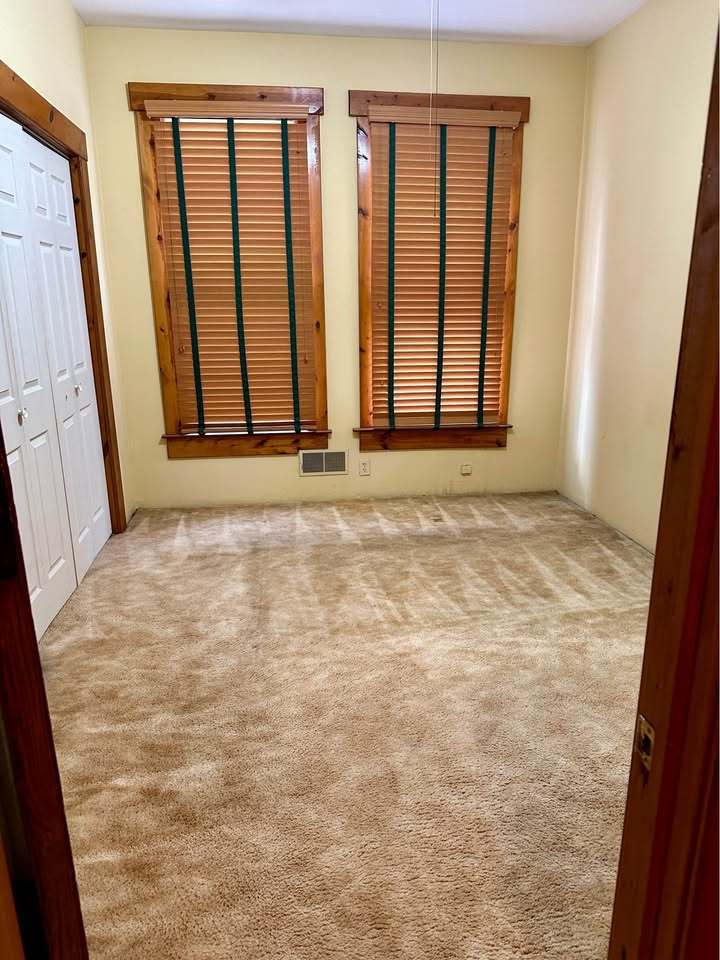230 Comstock Street, Unit 1 Joliet, IL 60436 - Photo 12 of 20 a view of an empty room with wooden floor and a window
