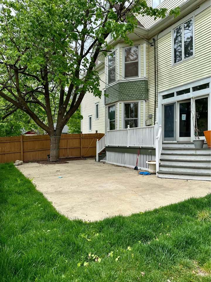 230 Comstock Street, Unit 1 Joliet, IL 60436 - Photo 14 of 20 a front view of a house with a yard and a garage