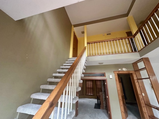 230 Comstock Street, Unit 1 Joliet, IL 60436 - Photo 18 of 20 a view of staircase with white walls and railing