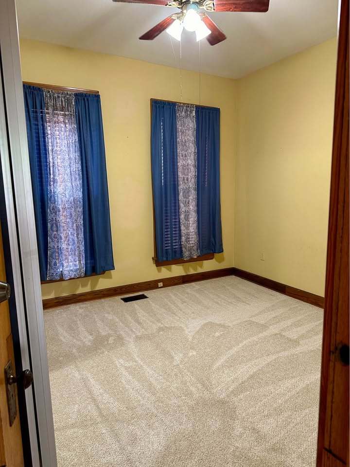 230 Comstock Street, Unit 1 Joliet, IL 60436 - Photo 9 of 20 an empty room with windows