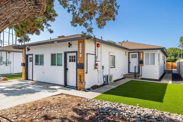 a front view of a house with a garden and yard