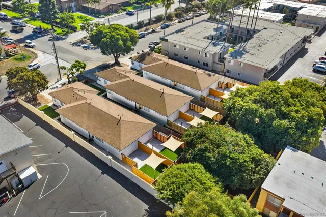 an aerial view of residential houses with outdoor space