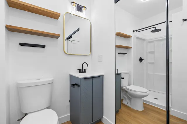 a bathroom with a toilet a sink and a shower