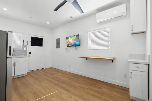 a view of a livingroom with an empty space & a window