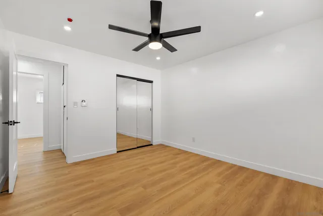 a view of empty room with wooden floor