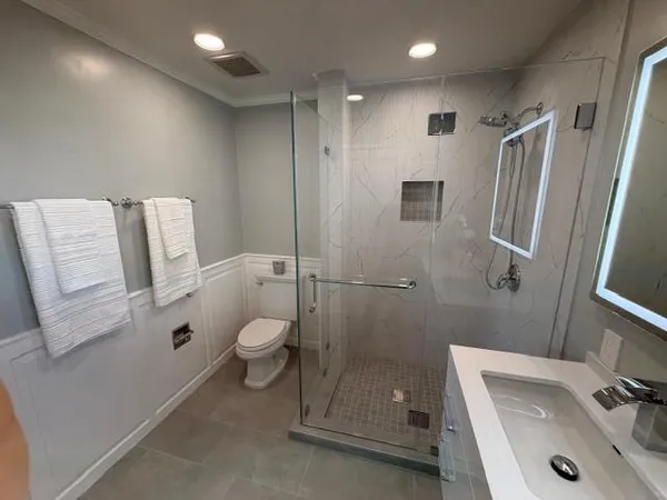 a bathroom with a sink toilet and shower