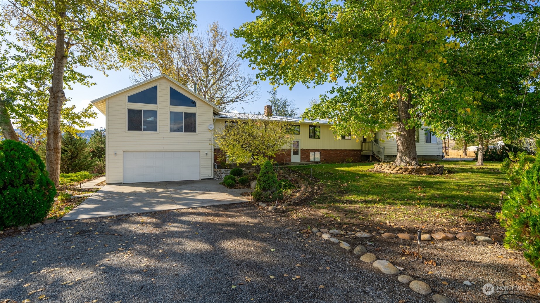 141 Johnson Creek Road Omak, WA 98841 - Photo 1 of 40 a front view of a house with garden