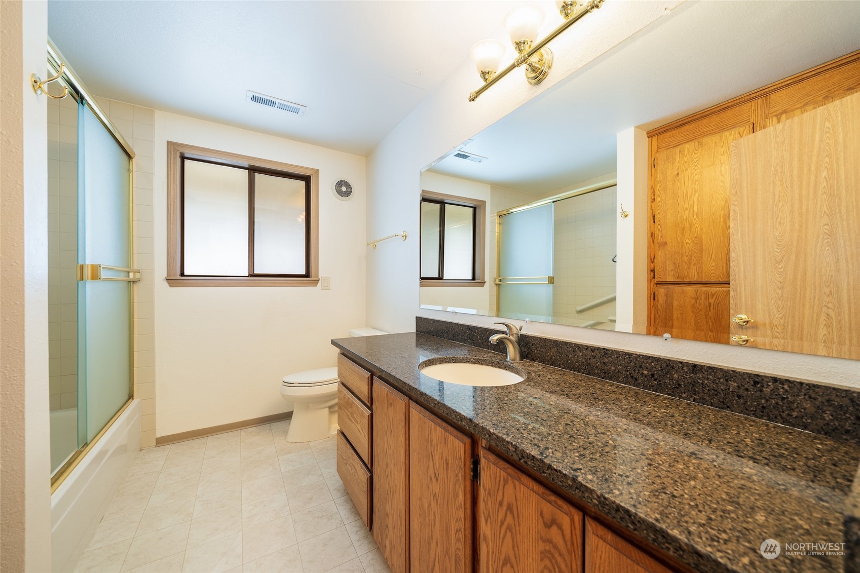 141 Johnson Creek Road Omak, WA 98841 - Photo 13 of 40 a bathroom with a granite countertop sink and a mirror