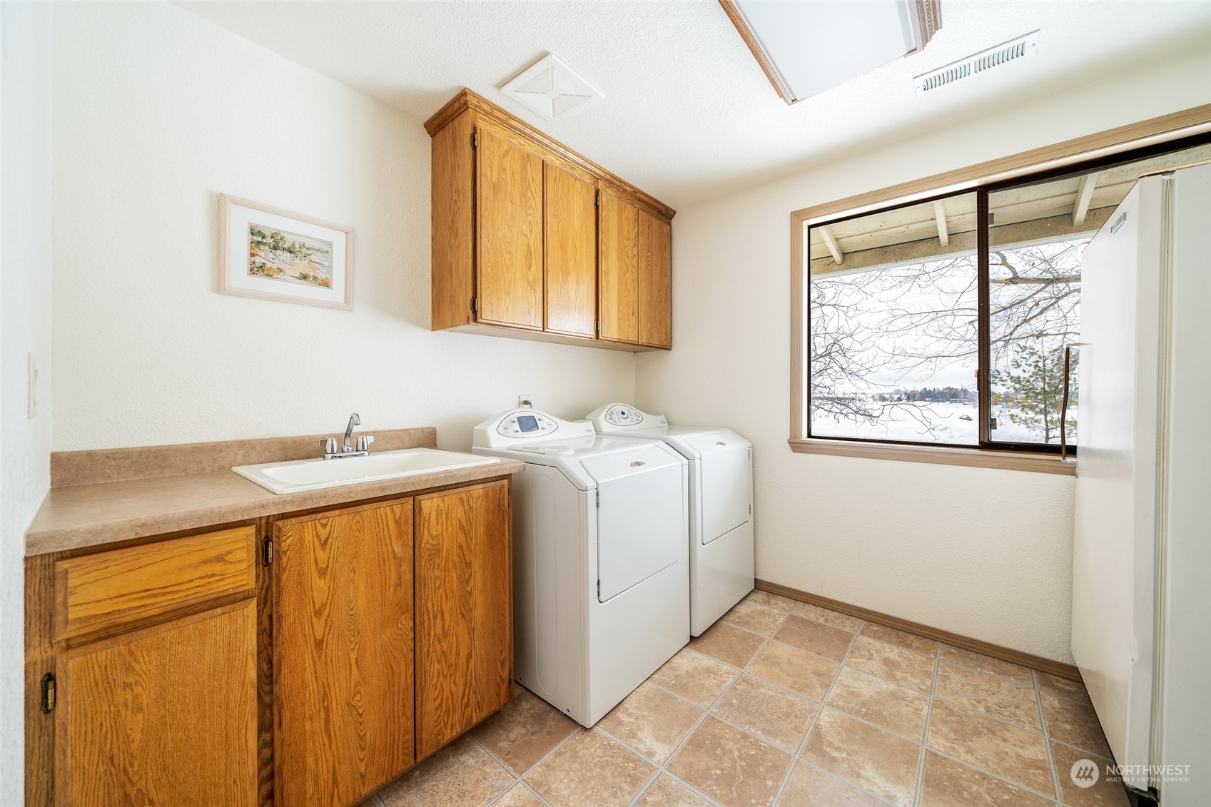 141 Johnson Creek Road Omak, WA 98841 - Photo 15 of 40 a bathroom with a granite countertop sink and a window