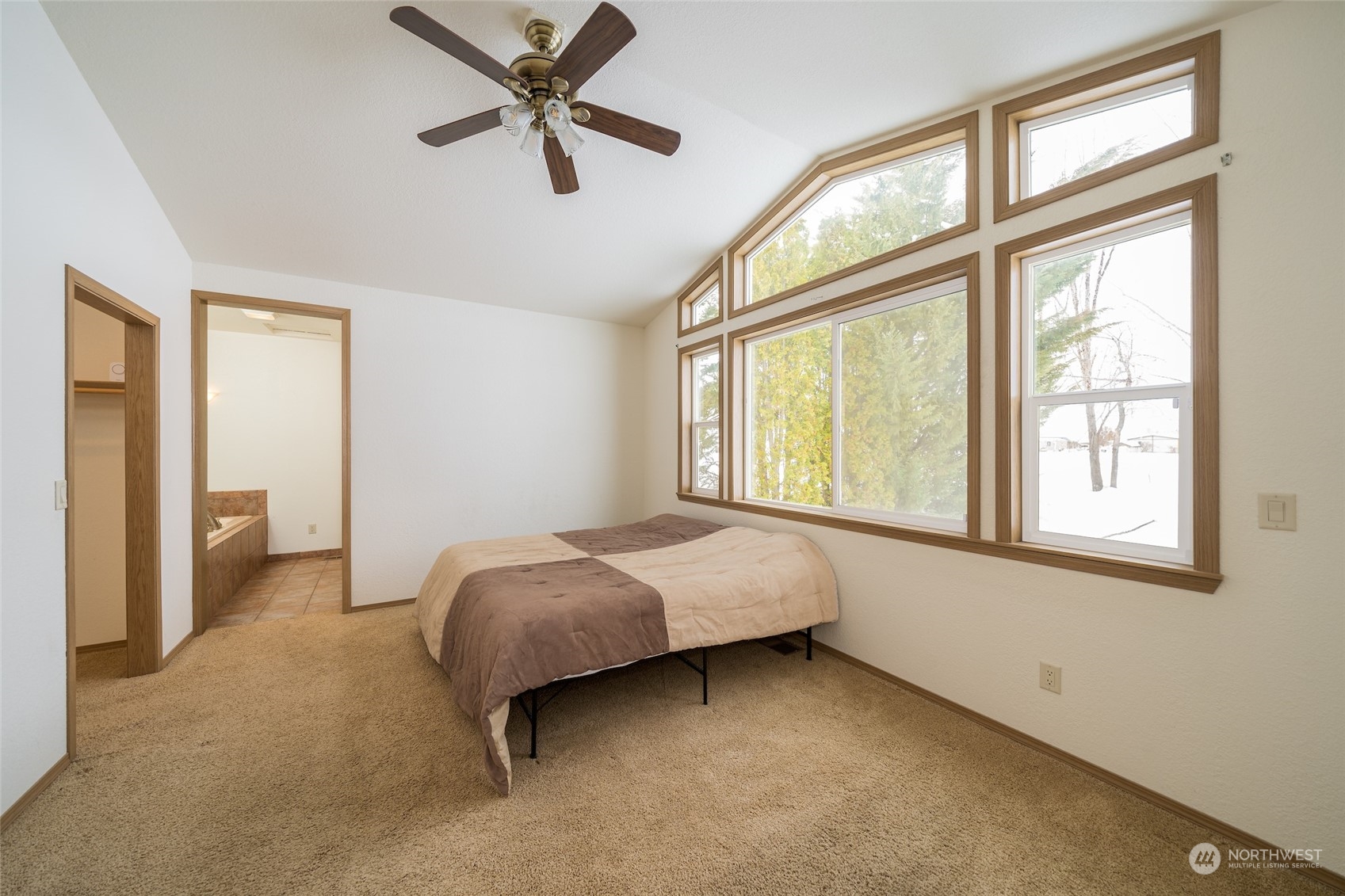 141 Johnson Creek Road Omak, WA 98841 - Photo 17 of 40 a bed room with a bed and a large window