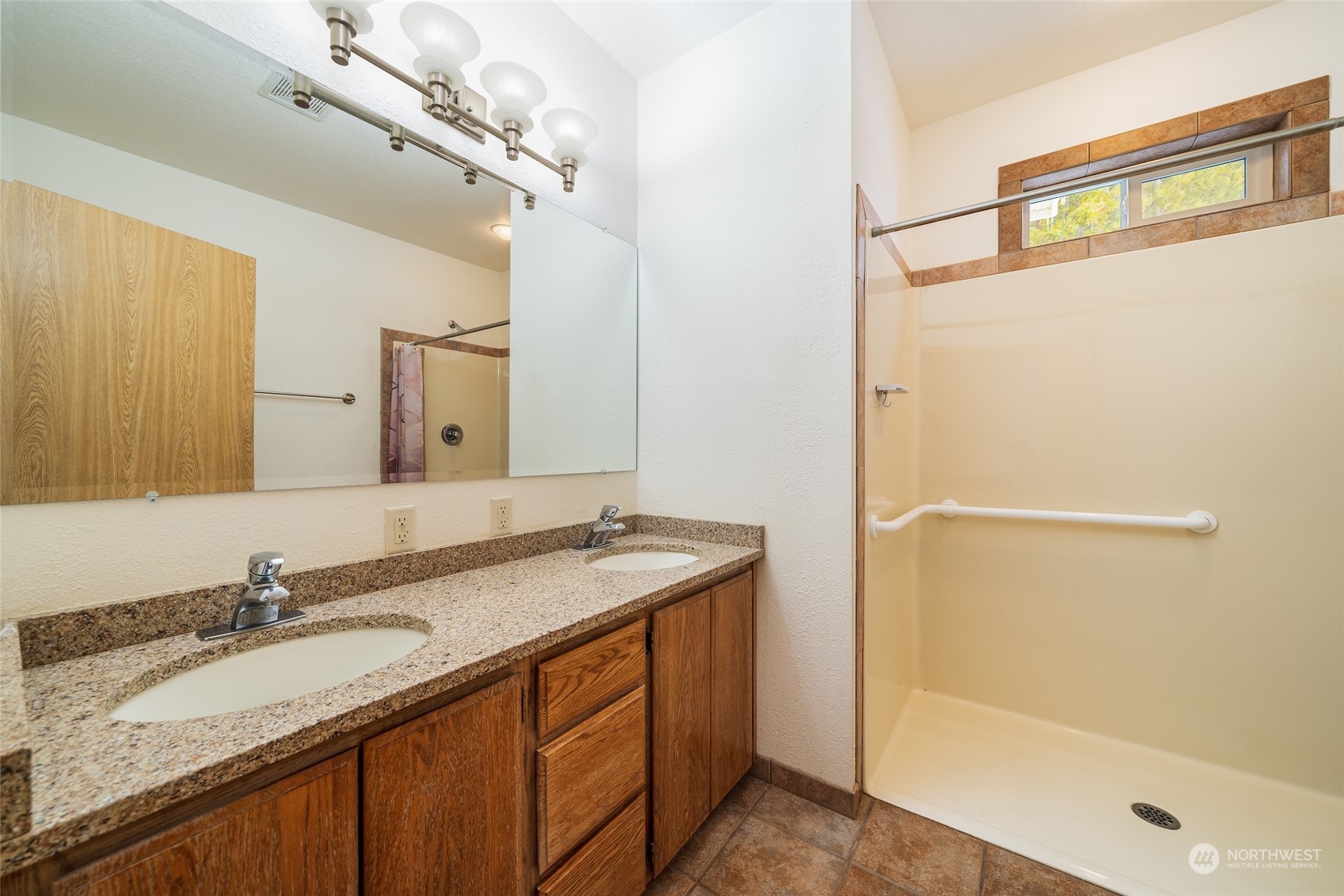 141 Johnson Creek Road Omak, WA 98841 - Photo 20 of 40 a bathroom with a granite countertop sink and a mirror