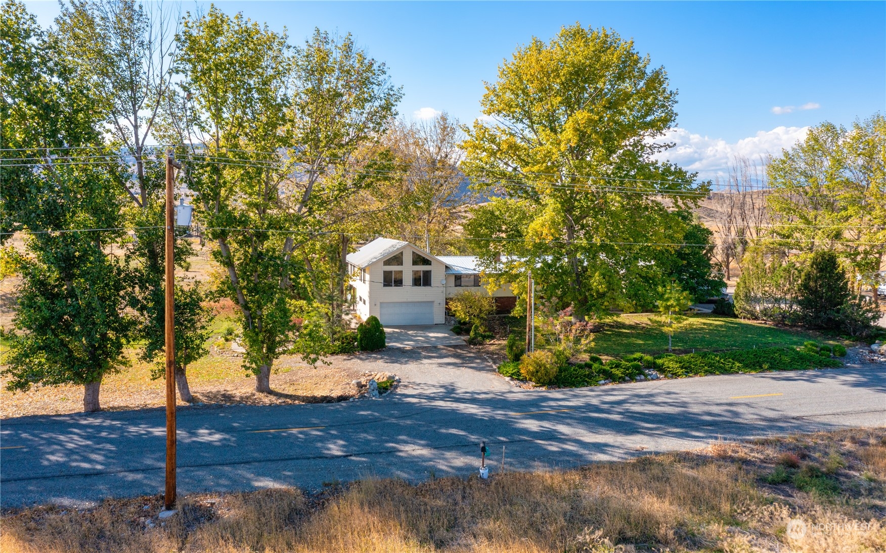 141 Johnson Creek Road Omak, WA 98841 - Photo 2 of 40 a view of a yard with plants and trees