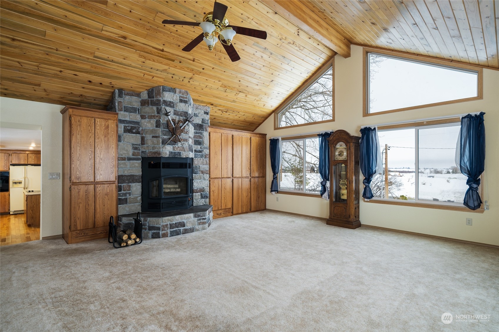 141 Johnson Creek Road Omak, WA 98841 - Photo 23 of 40 a view of an empty room with a fireplace and a window