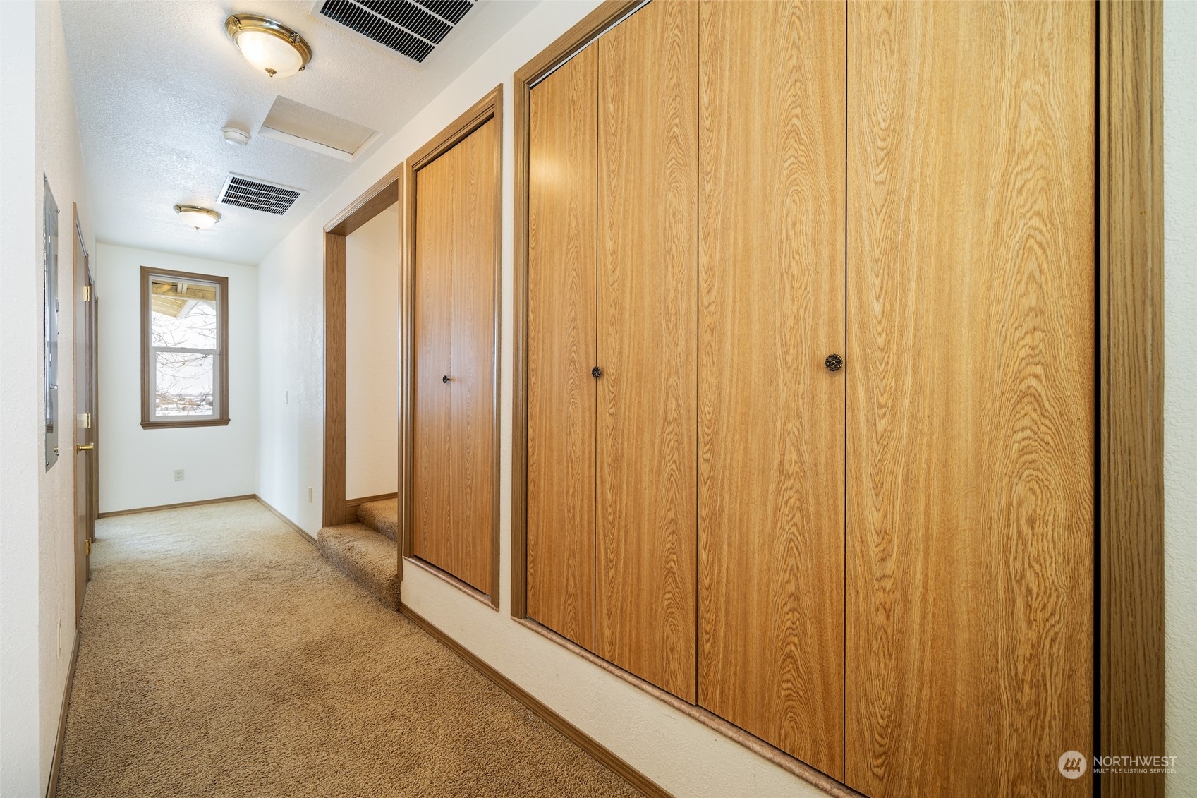 141 Johnson Creek Road Omak, WA 98841 - Photo 28 of 40 a view of a hallway with wooden walls