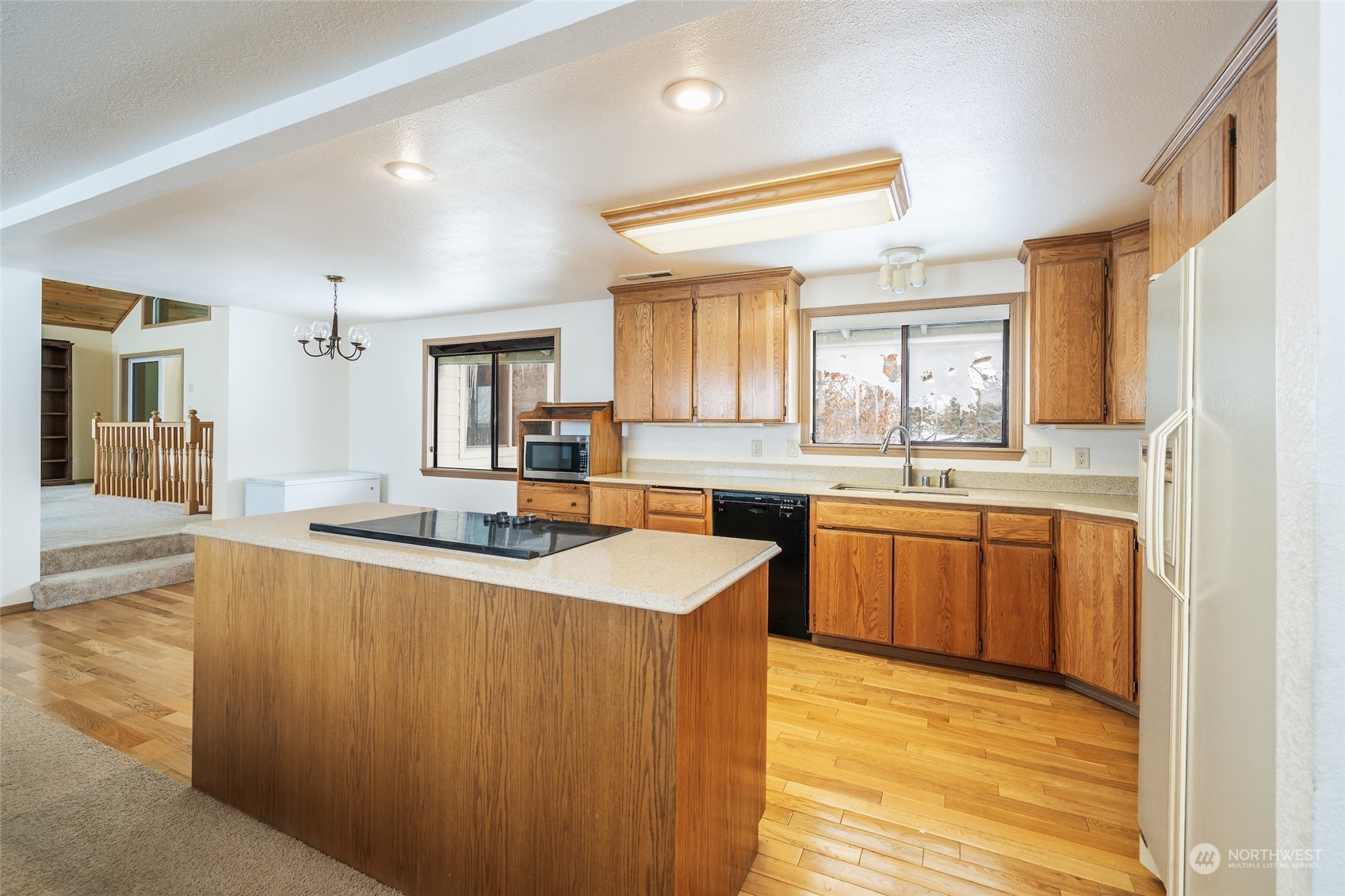 141 Johnson Creek Road Omak, WA 98841 - Photo 4 of 40 a large kitchen with kitchen island a sink stainless steel appliances and cabinets