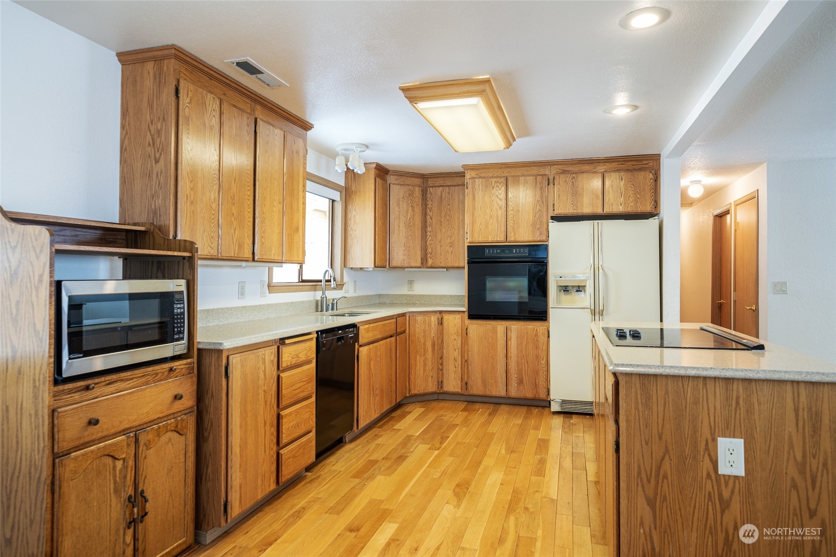 141 Johnson Creek Road Omak, WA 98841 - Photo 5 of 40 a kitchen with stainless steel appliances a sink cabinets and wooden floor
