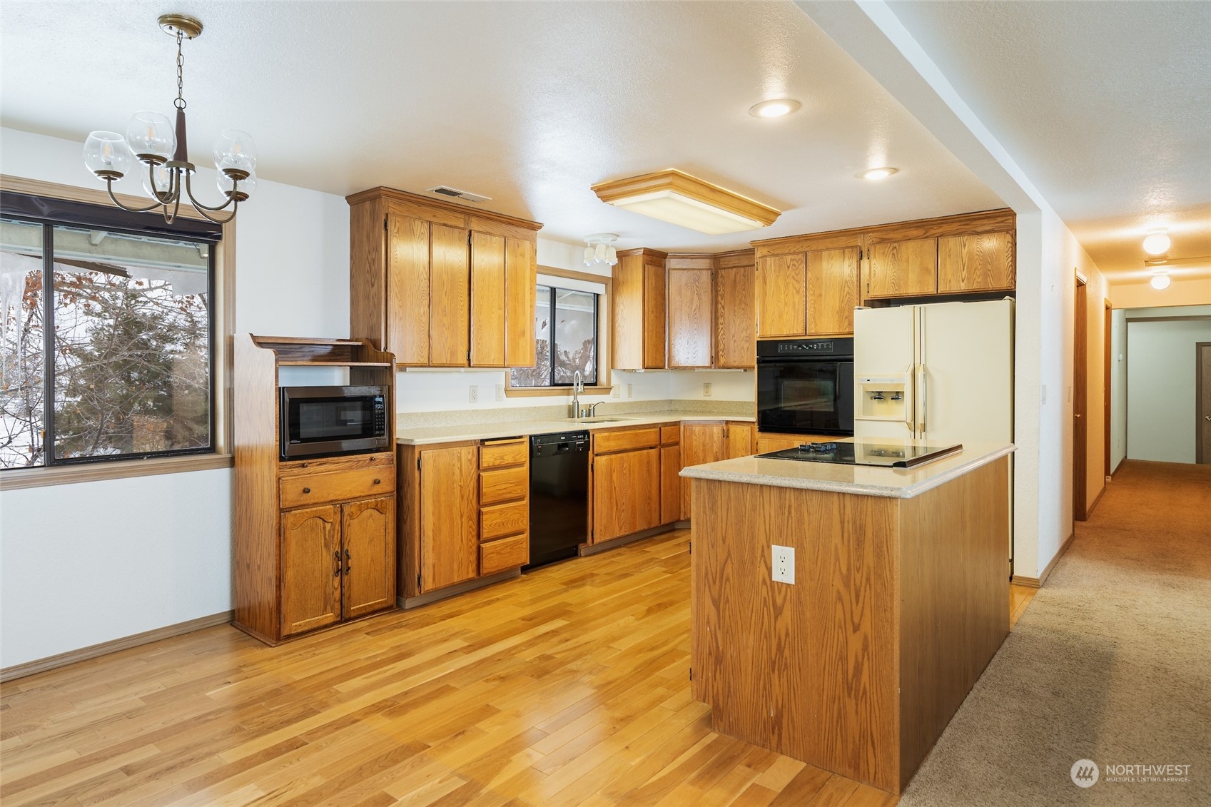 141 Johnson Creek Road Omak, WA 98841 - Photo 7 of 40 a kitchen with stainless steel appliances granite countertop a stove a sink dishwasher a refrigerator and a dining table with wooden floor