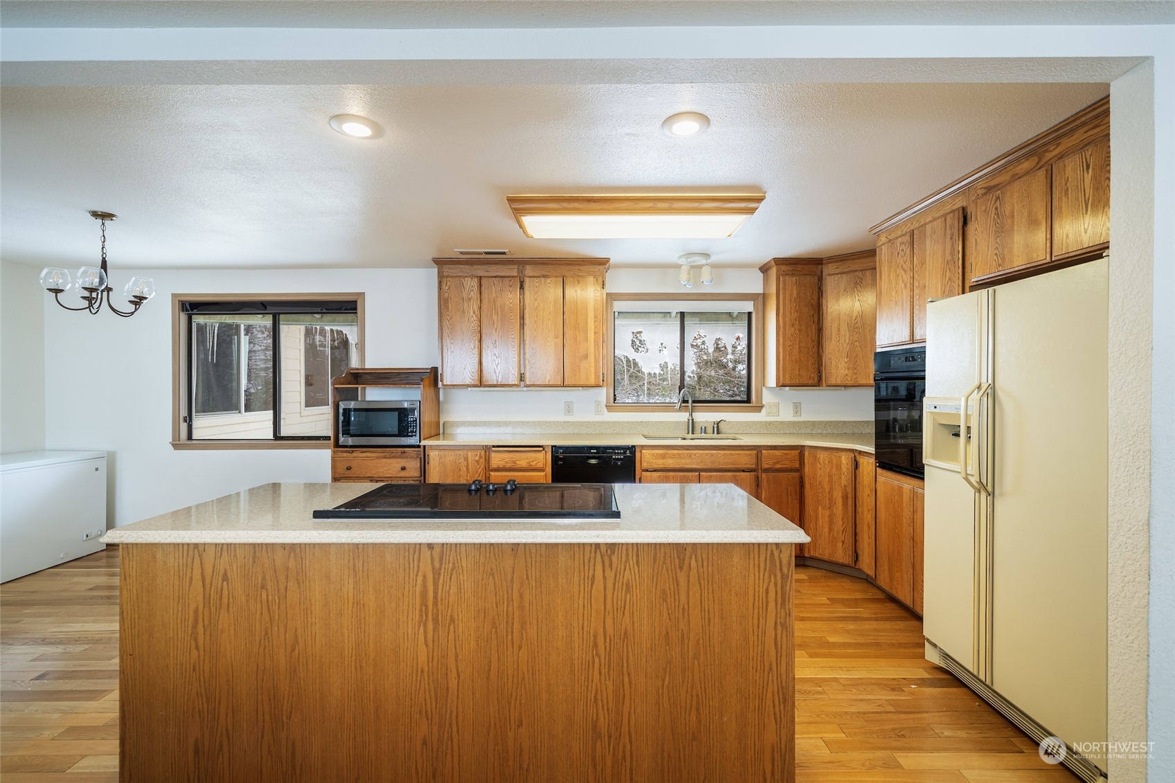 141 Johnson Creek Road Omak, WA 98841 - Photo 8 of 40 a large kitchen with stainless steel appliances a large counter top a stove and a refrigerator