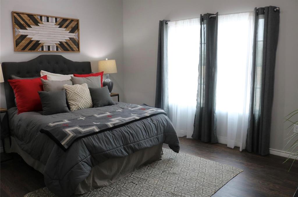 119 Dove Street Boyd, TX 76023 - Photo 13 of 18 a bed sitting in a bedroom next to a window