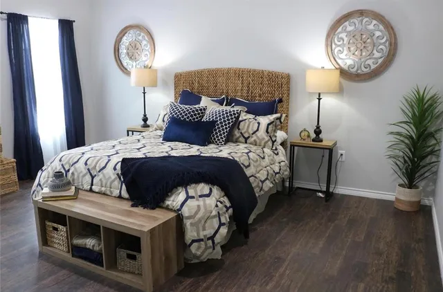 a bedroom with a bed and a chandelier